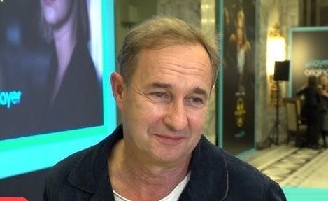 Marek Kalita przeglądający Instagram na smartfonie w swobodnym otoczeniu, symbolizujący jego aktywność w mediach społecznościowych.