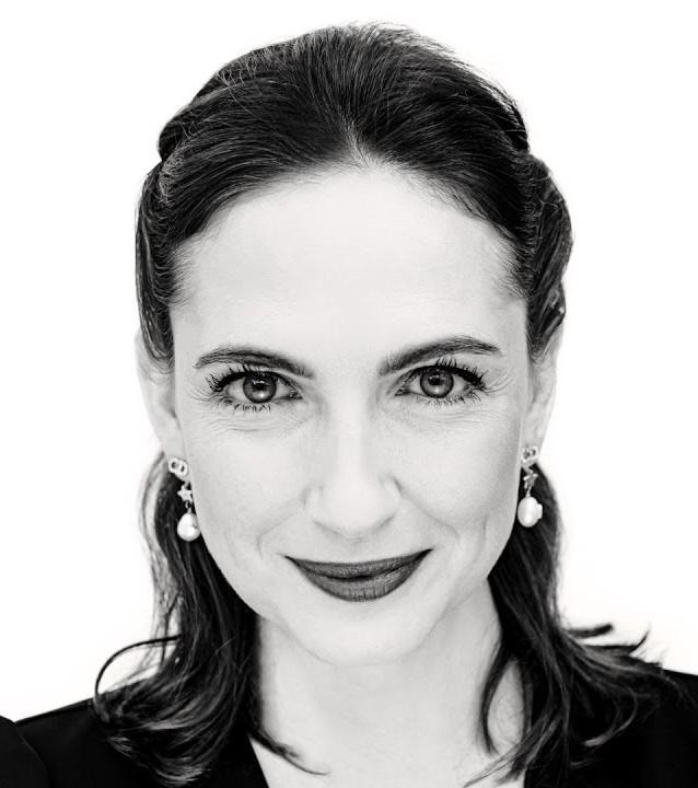 Anna Cieślak na scenie teatralnej, w dynamicznej pozie, z intensywnym wyrazem twarzy, podkreślonym dramatycznym oświetleniem.
